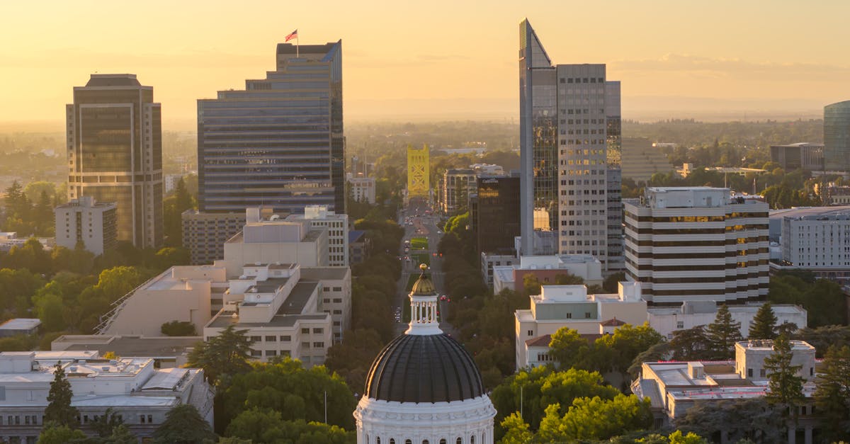 Aerial view of Sacramento skyline featuring the Capitol and Tower Bridge at sunset.
