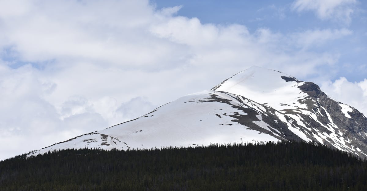 Stunning snow-capped mountain peaks under a vibrant sky in Colorado.