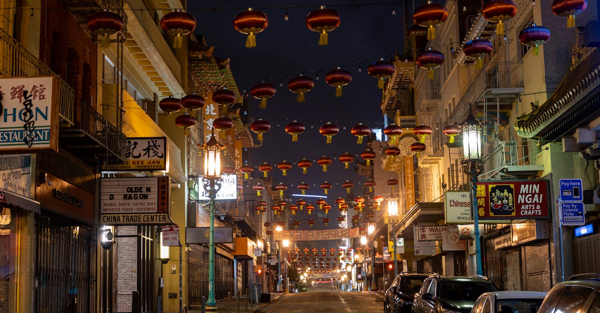 Empty street in Chinatown adorned with glowing lanterns at night, exuding a serene ambiance.