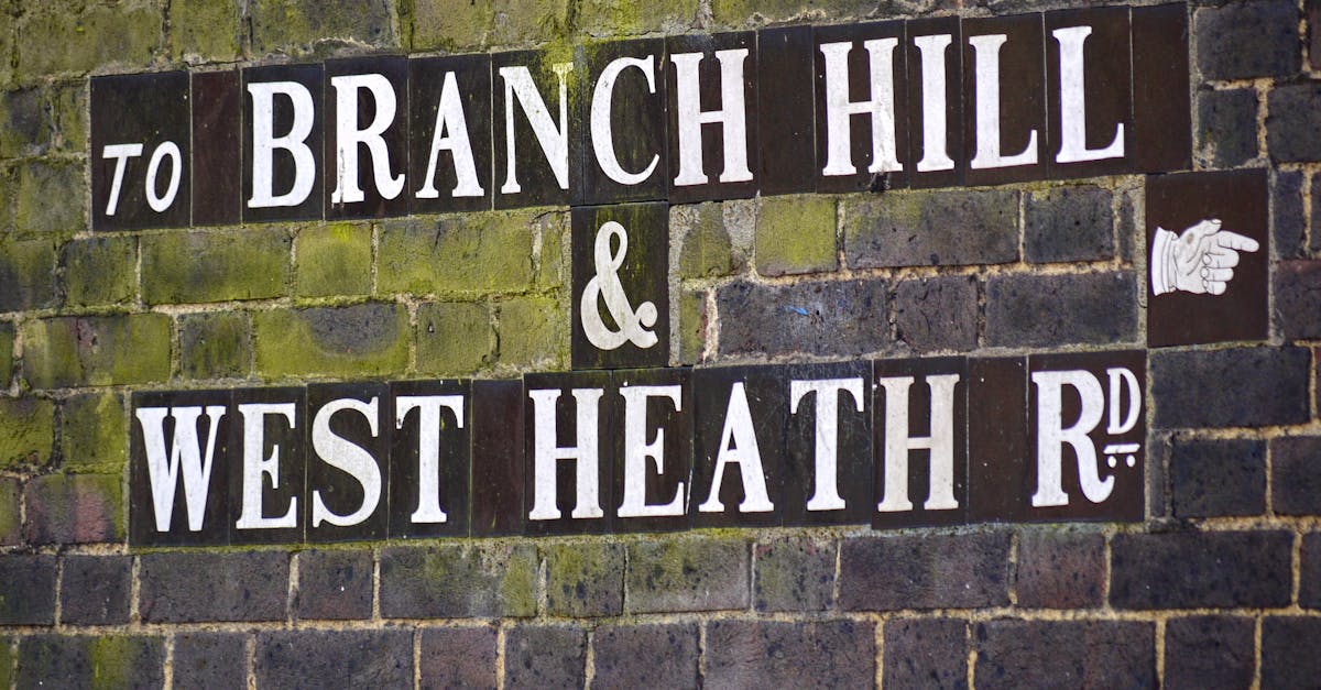 Vintage street sign directing to Branch Hill and West Heath Road in Hampstead.