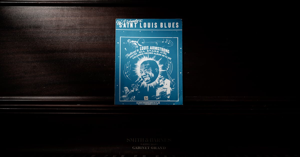 A vintage 'Saint Louis Blues' sheet music by Louis Armstrong displayed on a classic piano.