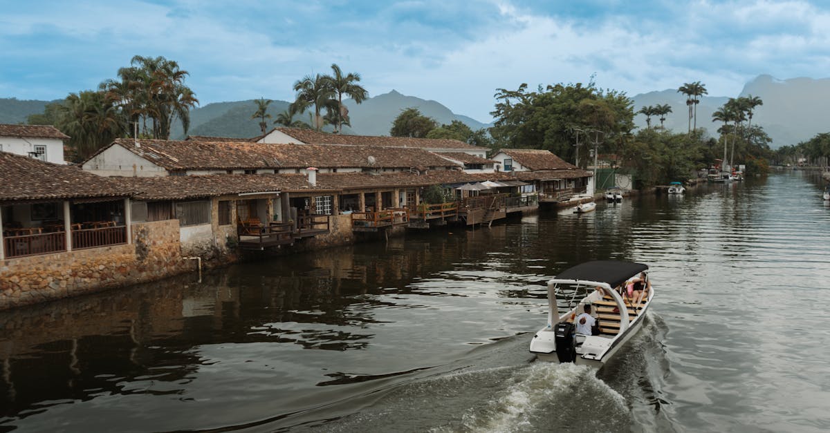 Explore a tranquil riverside village with lush greenery and a serene boat ride.