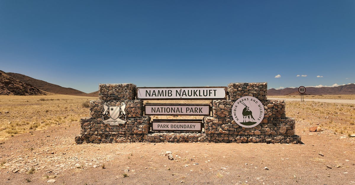 Namib-Naukluft National Park entrance sign under clear blue skies, capturing the desert landscape beauty.