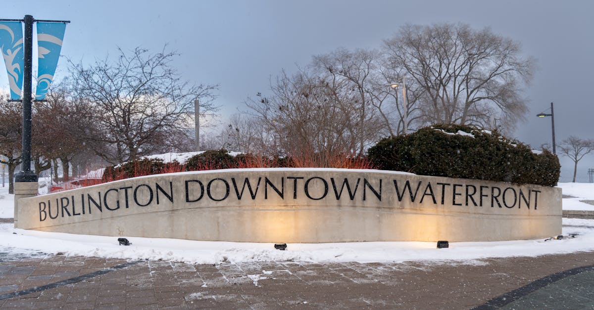 A tranquil winter scene at Burlington Downtown Waterfront with snow and distinctive signage.