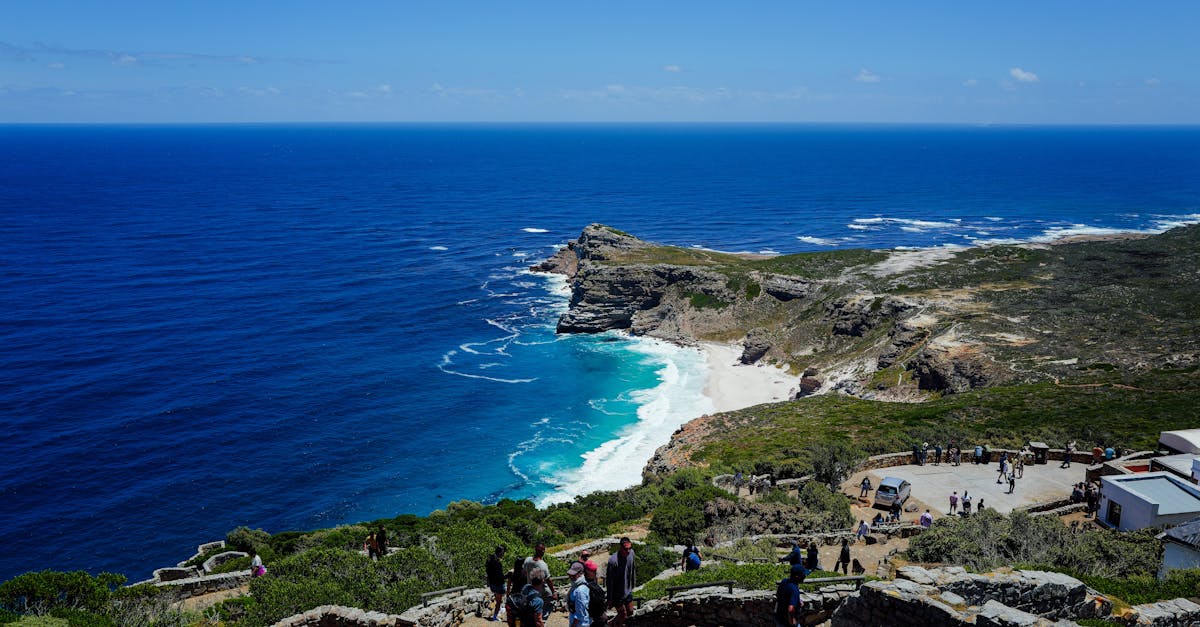 Stunning aerial view of the Cape of Good Hope with tourists exploring the scenic coastline.