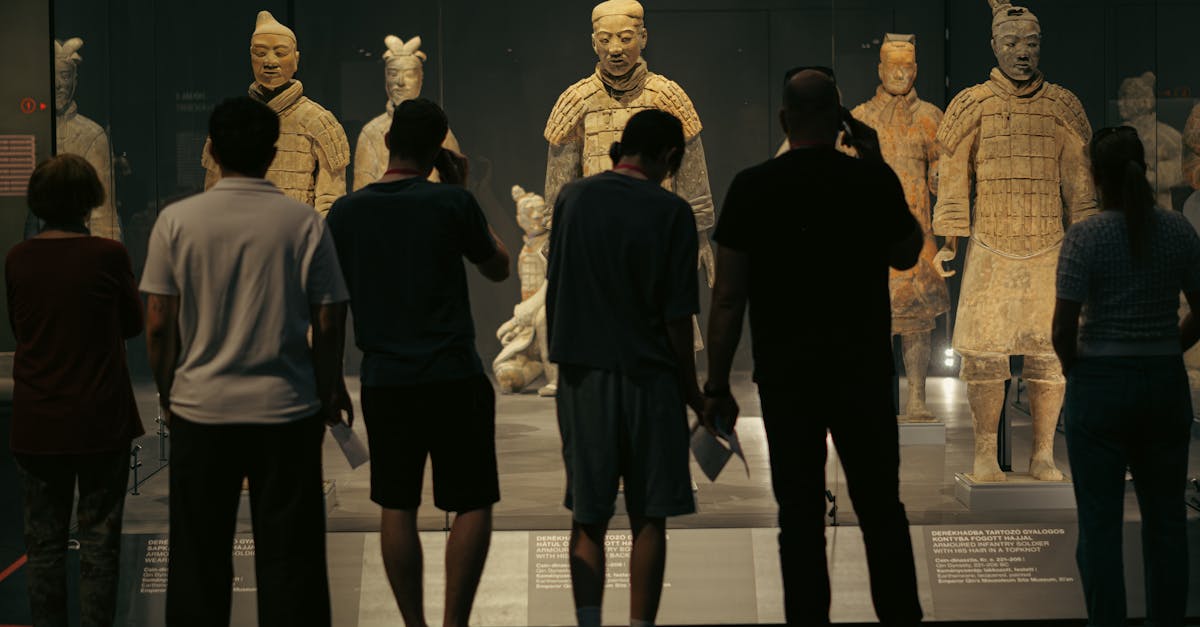 People observing the Terracotta Warriors exhibit at a museum in Budapest, Hungary.