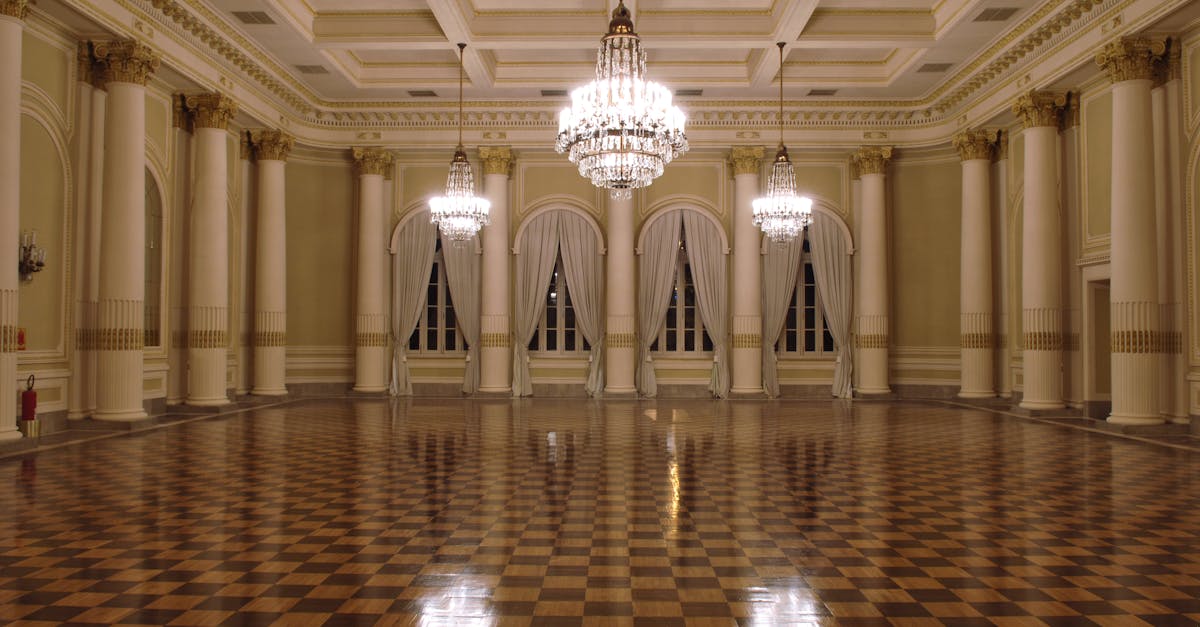 Luxurious ballroom with gleaming chandeliers and polished checkered floor, perfect for formal events.