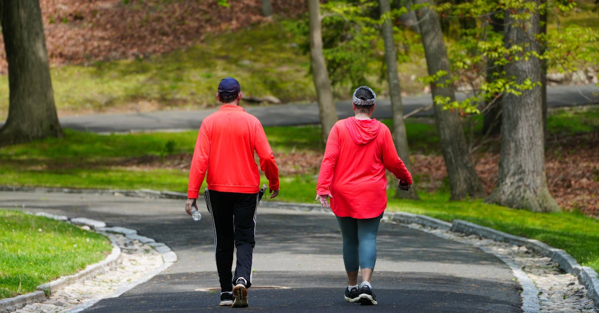 A couple enjoys a walk through a lush green park on a bright spring day.