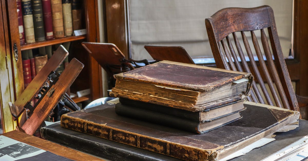 A collection of vintage books and classic wooden furniture in an antique library setting, highlighting history and literature.