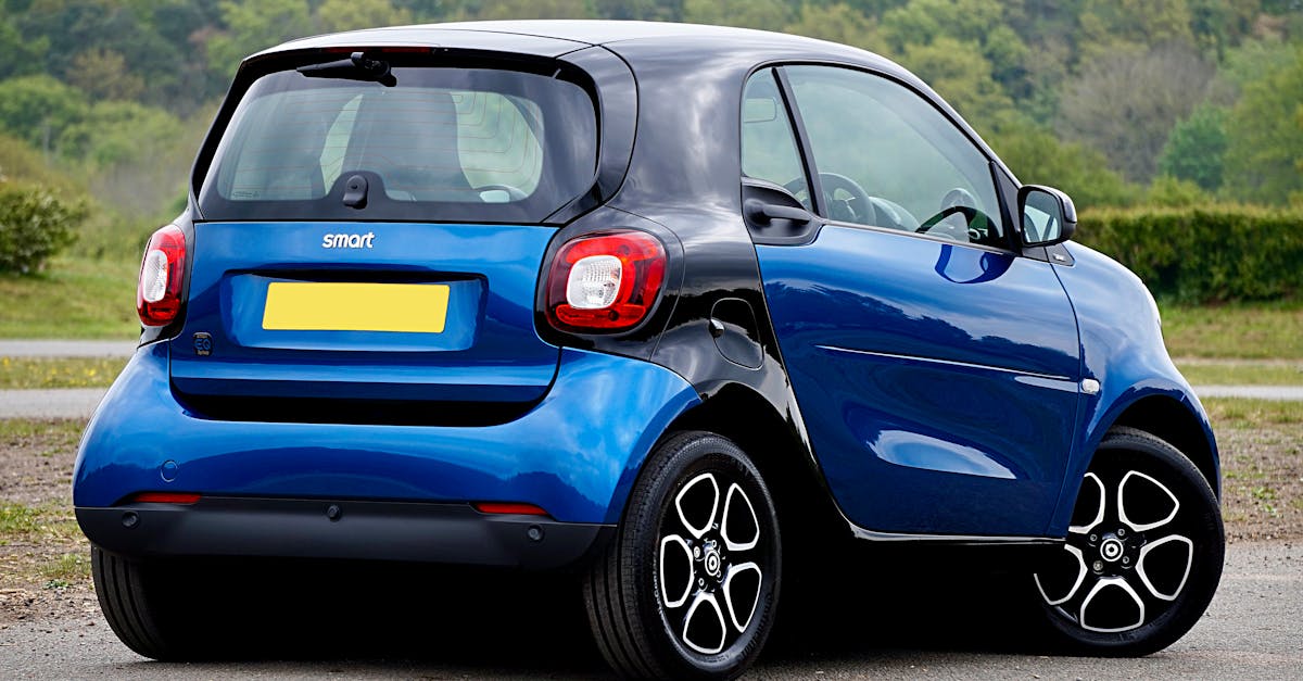A blue Smart car parked in a scenic outdoor setting, showcasing modern design and compact size.