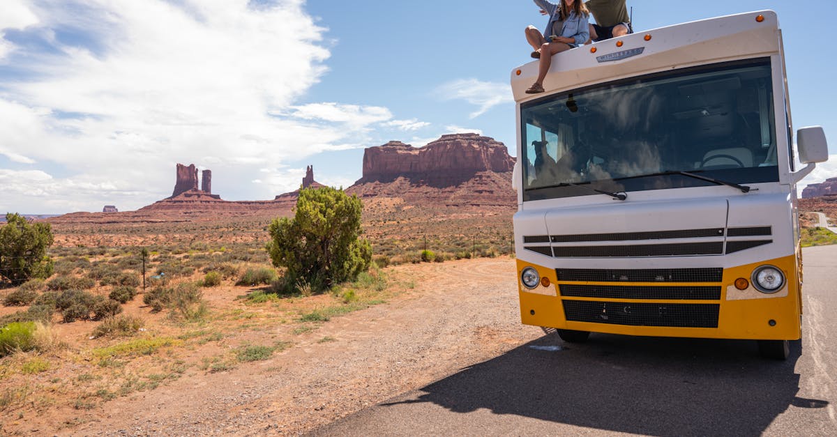 Couple enjoying a summer RV road trip in Monument Valley, Utah.