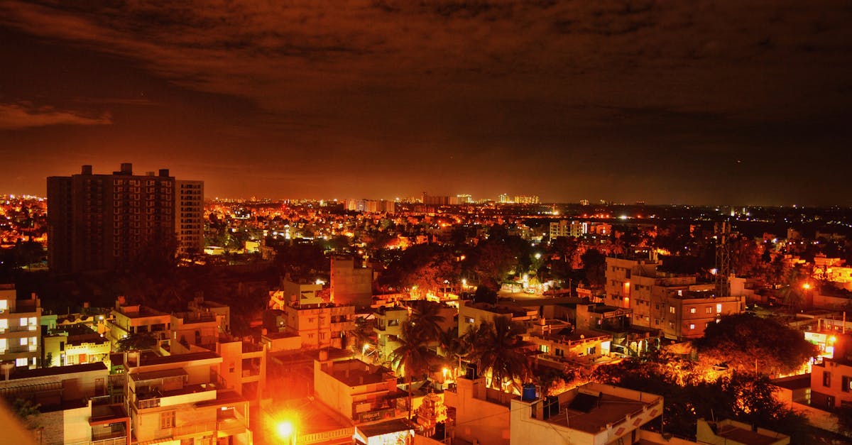 Vibrant view of Bengaluru cityscape at night, showcasing illuminated buildings and dynamic skyline.