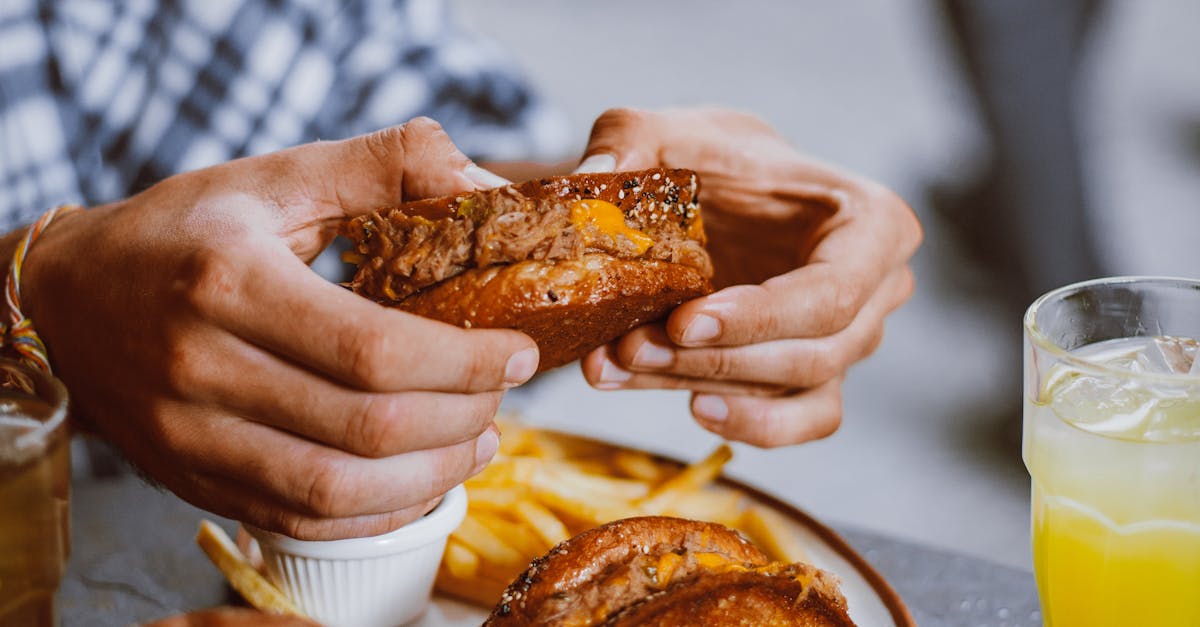 Delicious beef sandwich with fries and drinks, perfect for a casual meal.