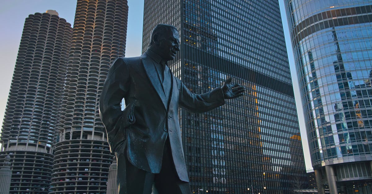 Photograph of Irv Kupcinet statue against Chicago's iconic skyscrapers during the day.