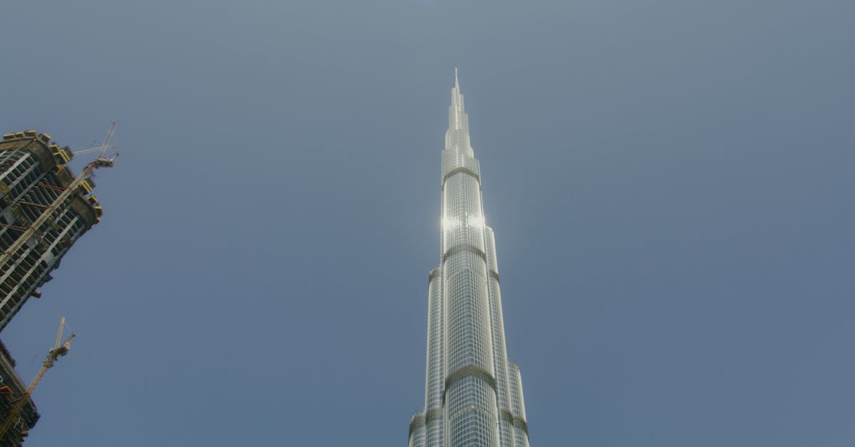 Low angle shot of the iconic Burj Khalifa towering against a clear blue sky in Dubai.