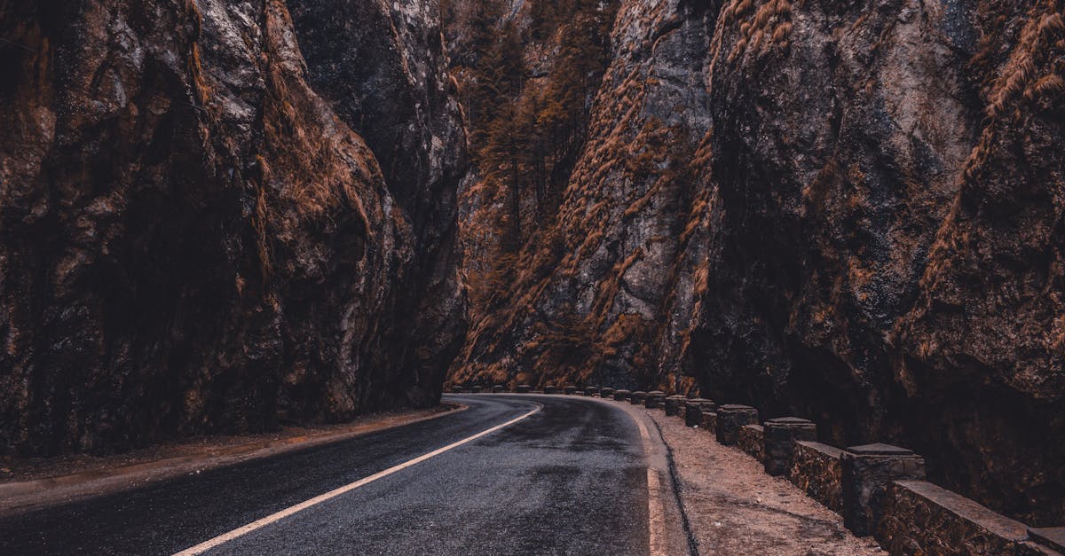 A winding road through the dramatic Bicaz Gorge, showcasing towering rock formations.