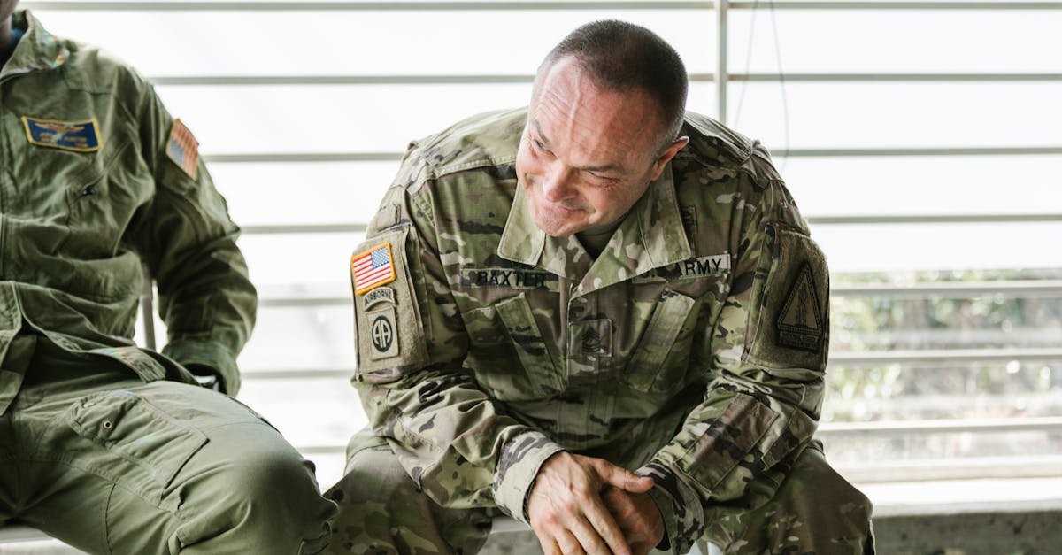 Military veterans in camouflage uniforms attending a supportive group therapy session.