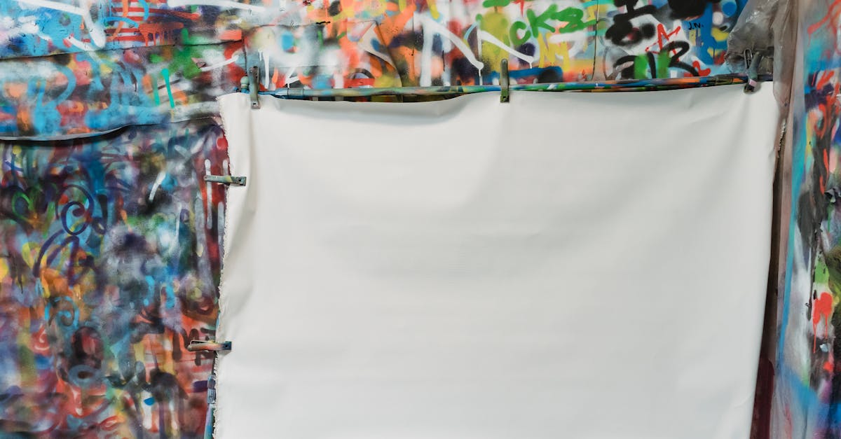 A vibrant graffiti wall with a blank white canvas in front for creative projects.
