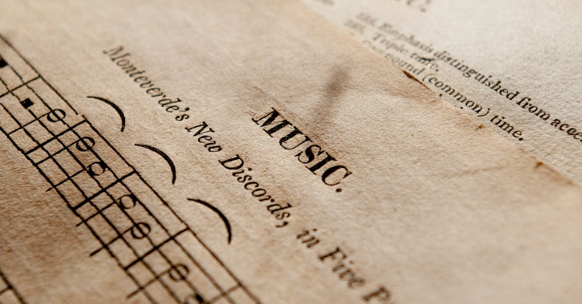 Detailed view of antique music sheets featuring notes and Monteverde's New Discords in sepia tone.
