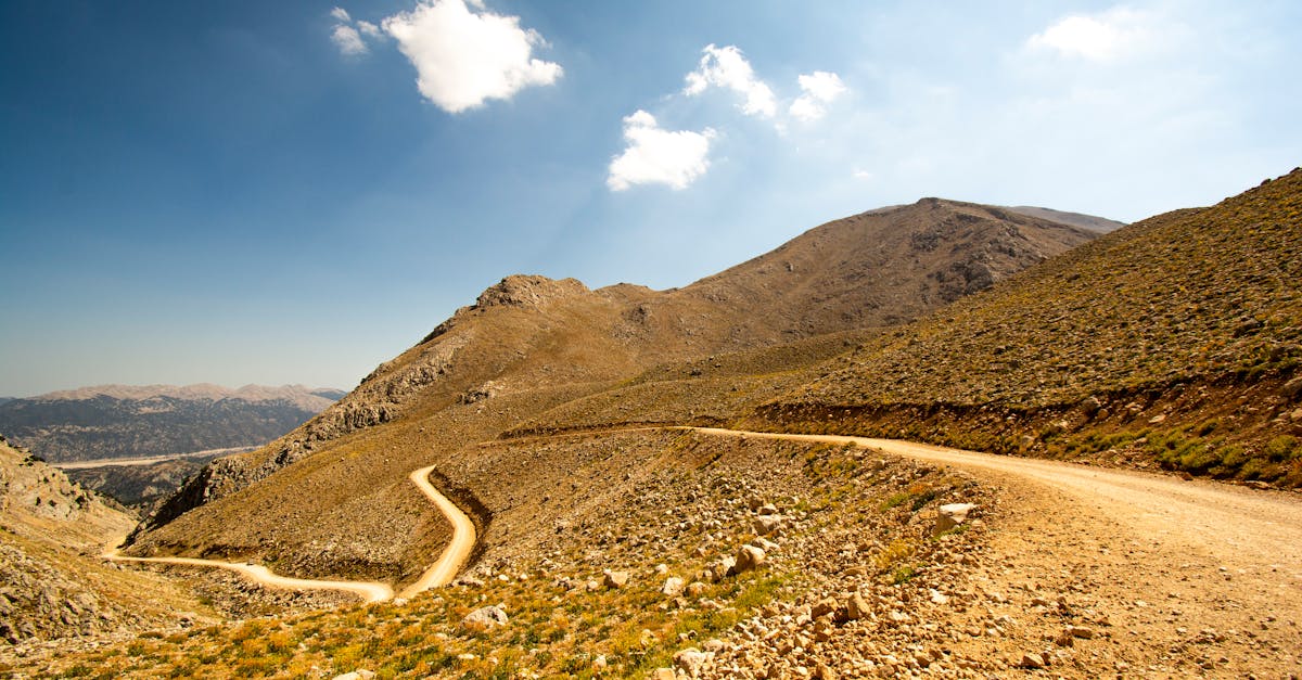 Scenic mountain landscape with a winding road in Gömbe, Antalya, Türkiye under a clear sky.