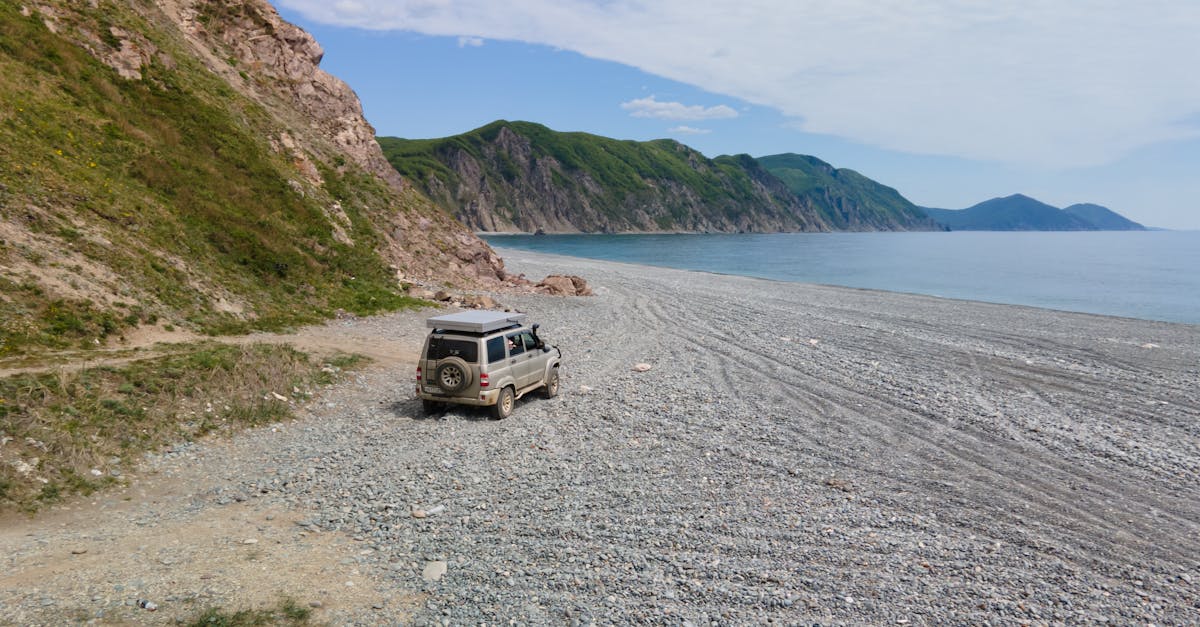 SUV driving along the scenic coastline of Primorsky Krai, Russia, showcasing adventure and nature.