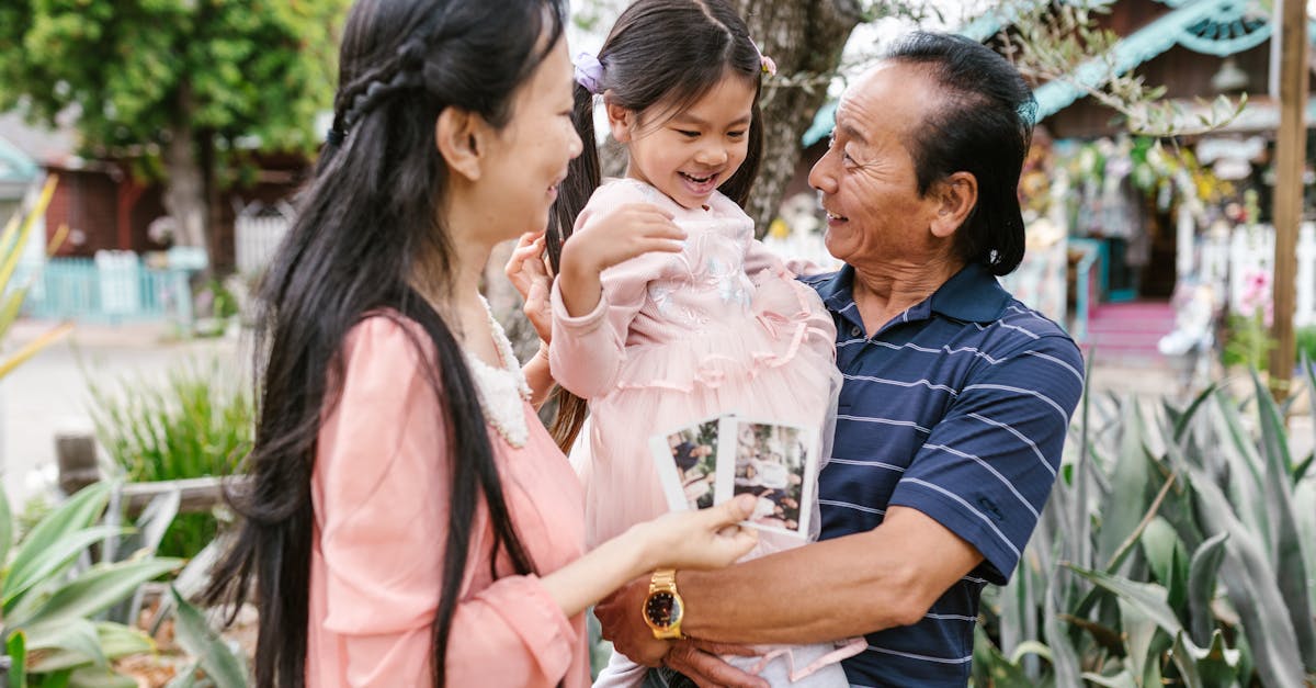 A joyful family scene with grandparents and child bonding outside.