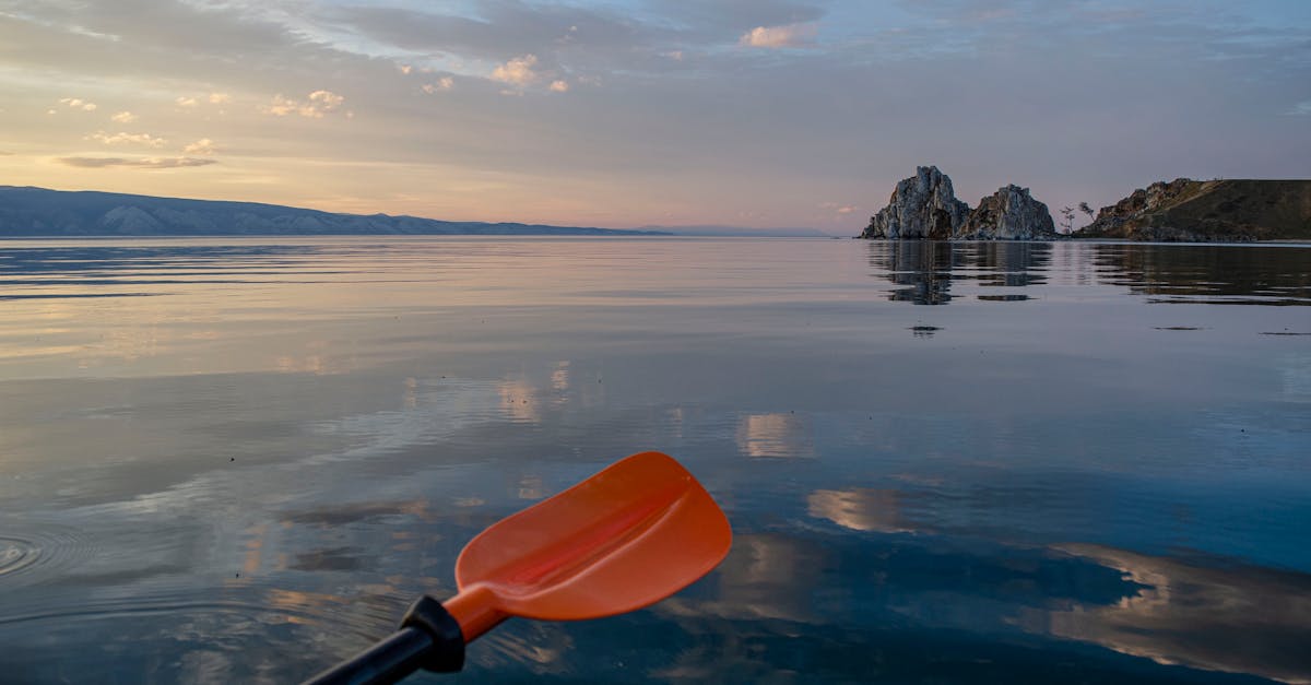 Peaceful sunset paddle on a calm lake with stunning reflections and scenic views.