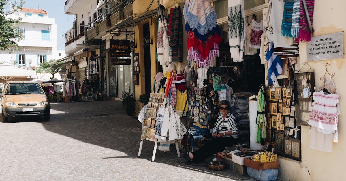 Charming street market in Chania, Greece, with vibrant textiles and local crafts on display.
