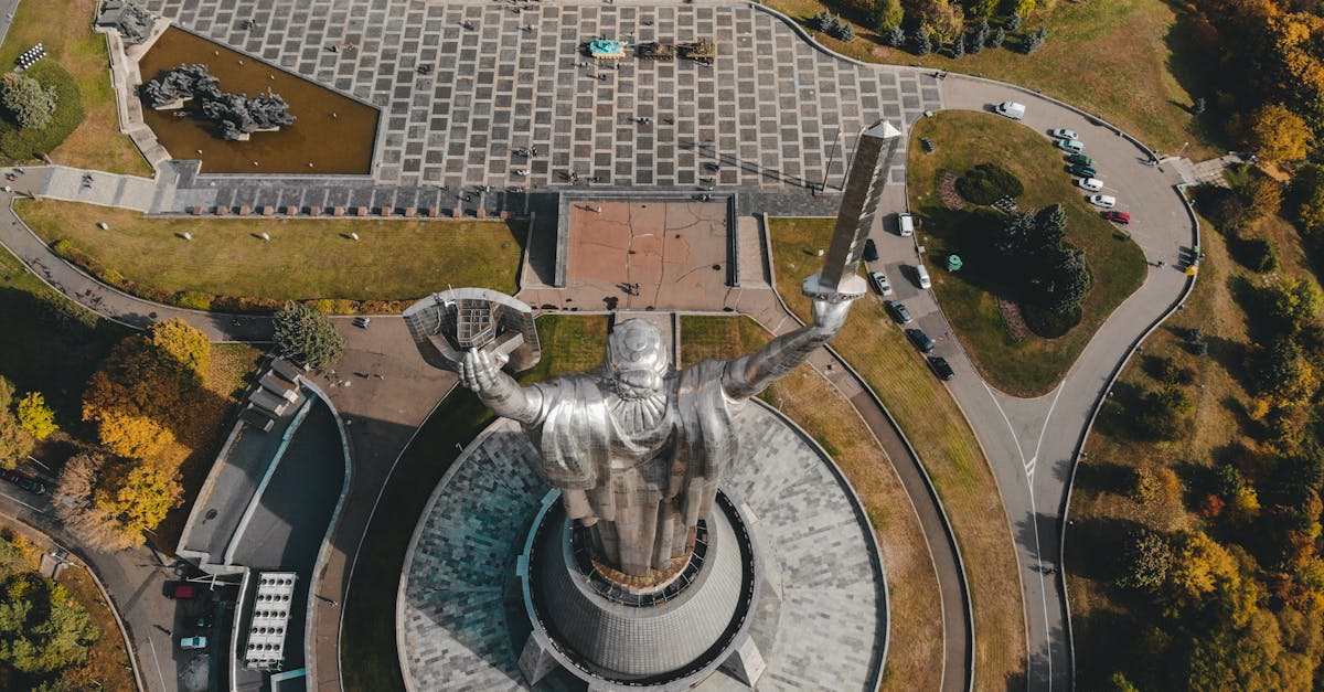 Stunning aerial view of the Motherland Monument in Kyiv, surrounded by lush greenery.